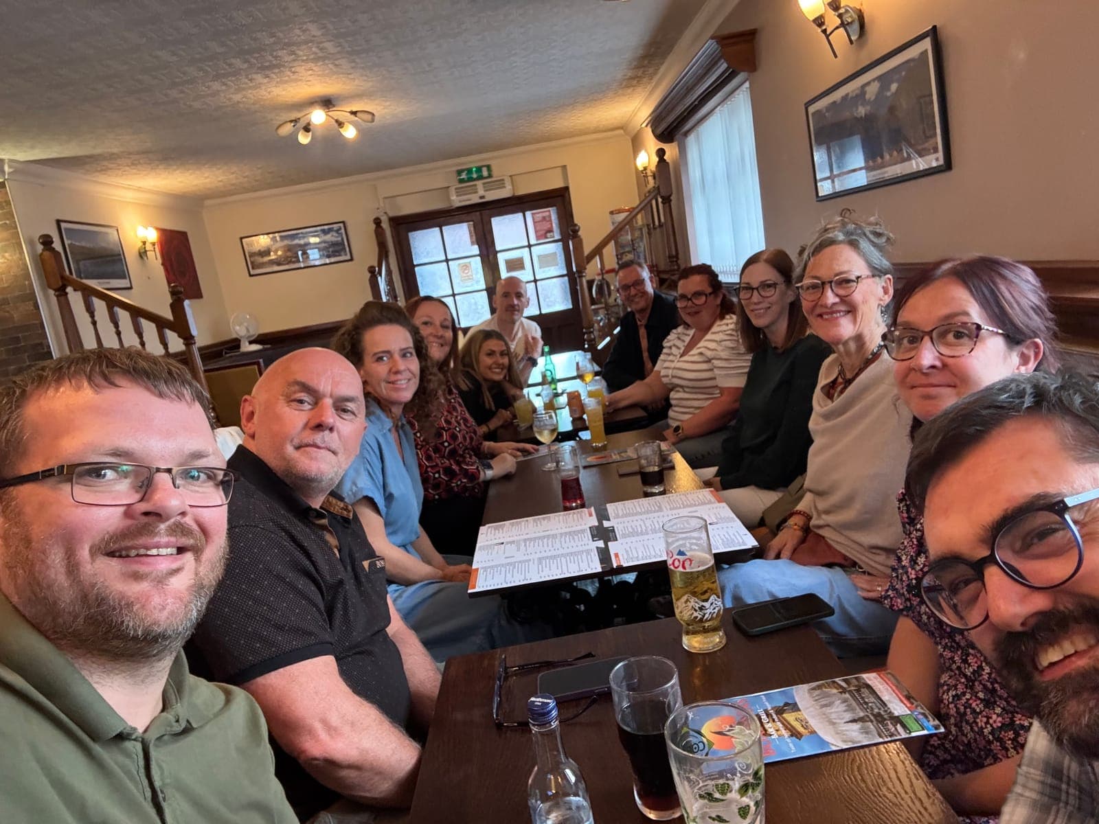 Workshop delegates around a pub table after a training day